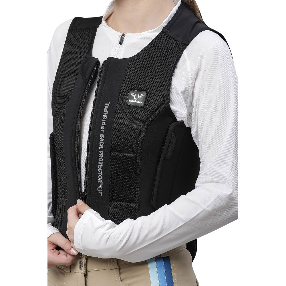 Person wearing a black back protector vest with visible branding on a white background