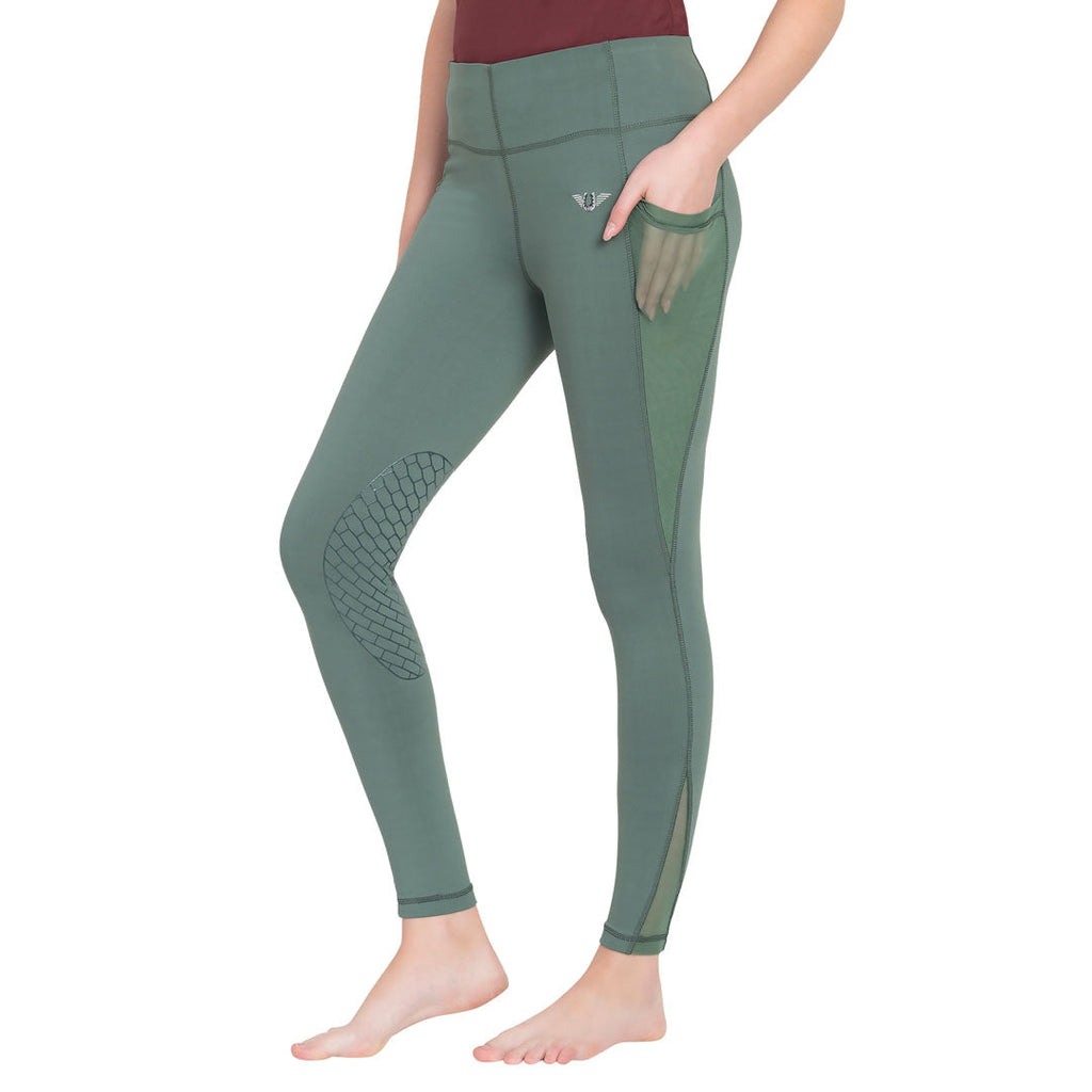 Green leggings with textured panels on a white background