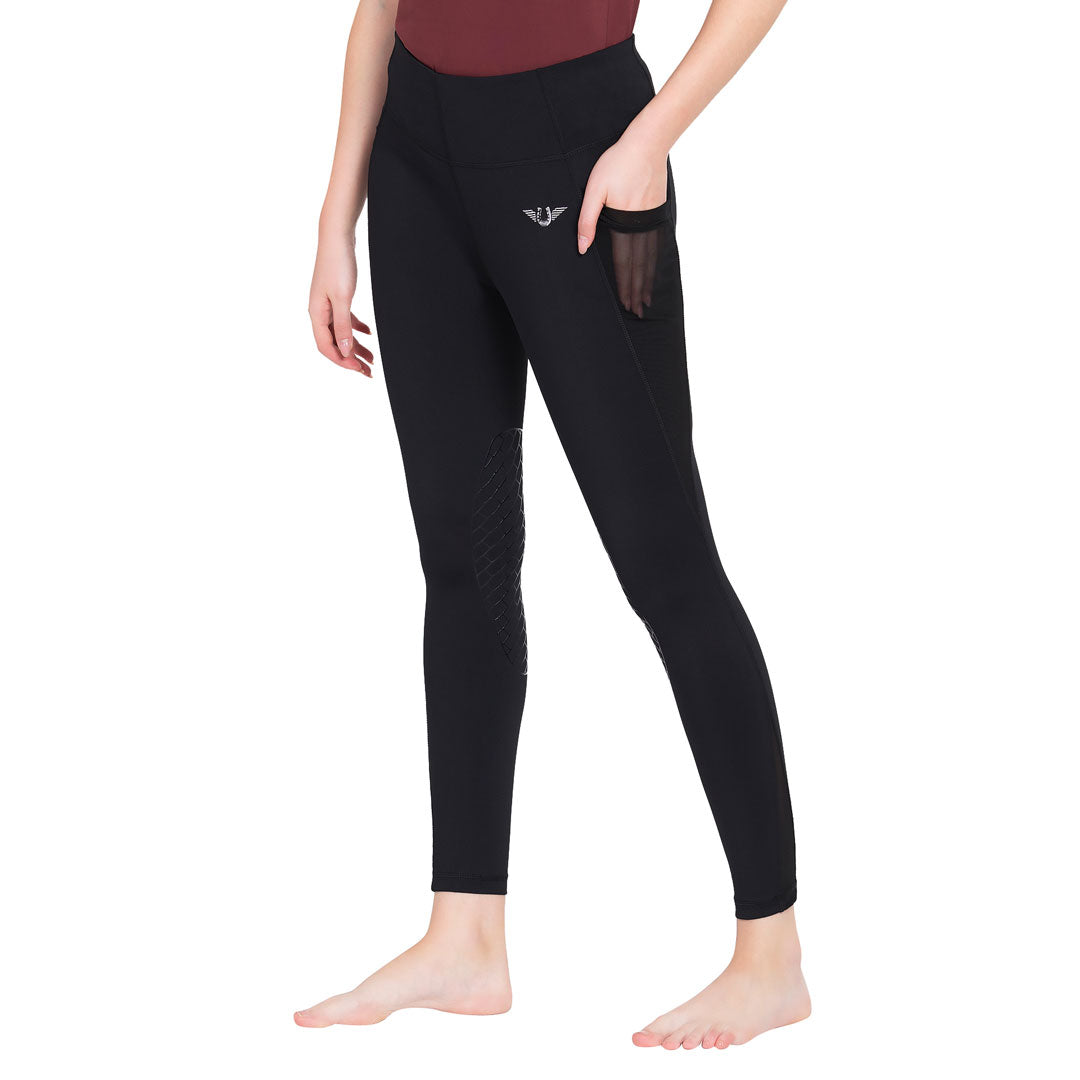 Person wearing black leggings with a small logo on a white background