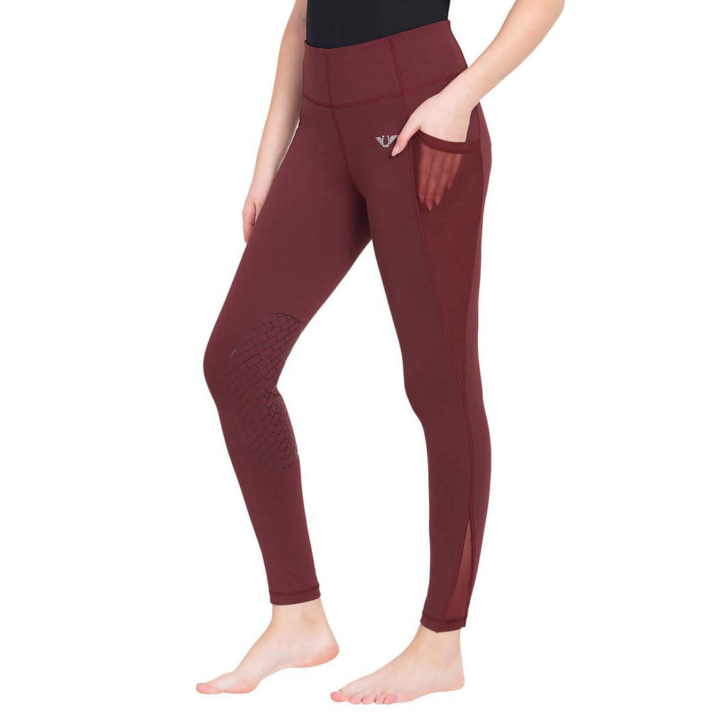 Maroon leggings worn by a person on a white background
