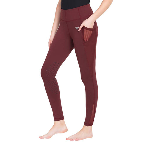 Maroon leggings worn by a person on a white background