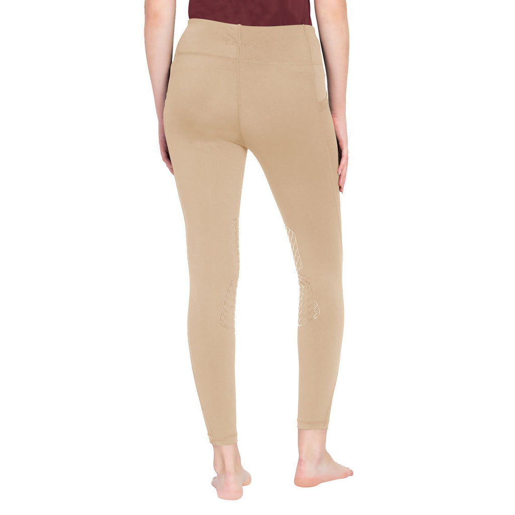 Beige leggings worn by a person on a white background