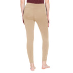 Beige leggings worn by a person on a white background