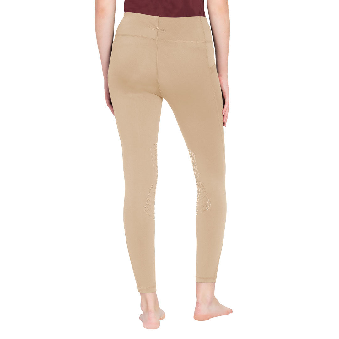 Beige leggings worn by a person on a white background