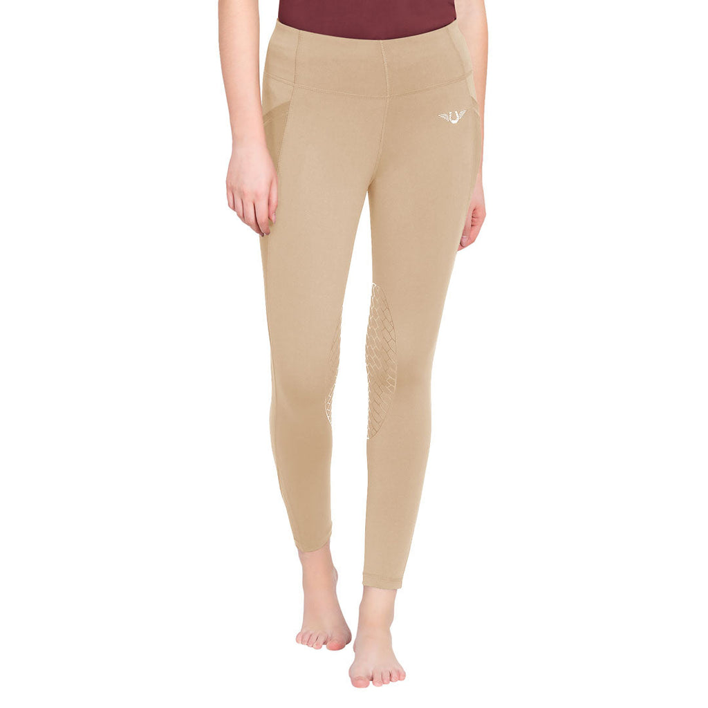 Beige leggings worn by a person on a white background