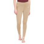 Beige leggings worn by a person on a white background