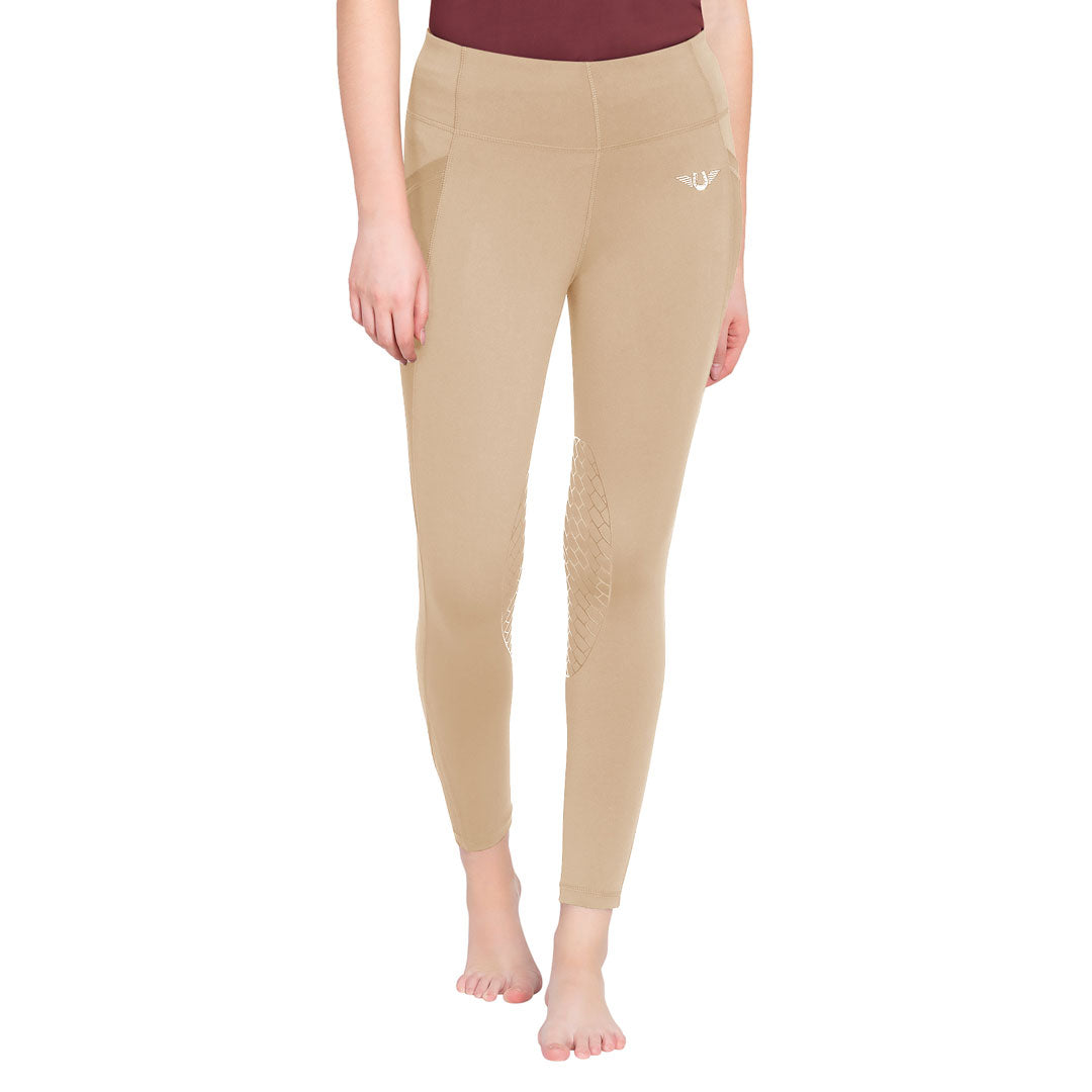Beige leggings worn by a person on a white background