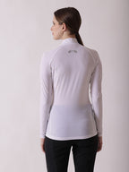 woman standing in a long sleeve athletic top