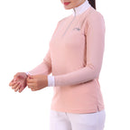 Person wearing a light pink long-sleeve top with a white collar on a white background