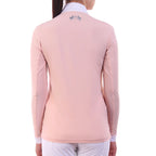 Person wearing a light pink long-sleeve equestrian shirt with a logo on the back against a white background