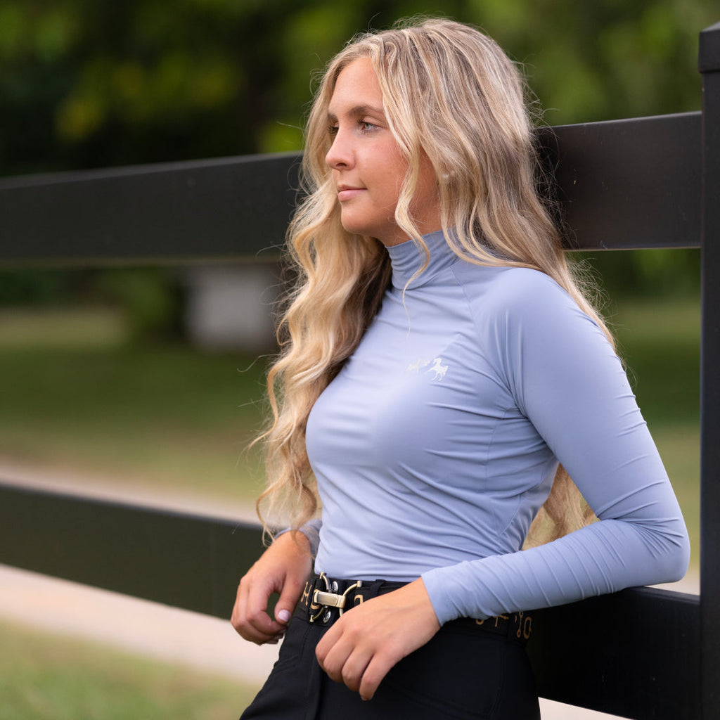 Woman wearing a light blue long-sleeve top outdoors