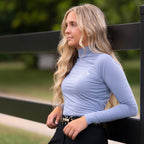 Woman wearing a light blue long-sleeve top outdoors