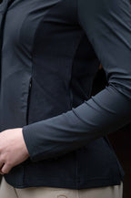 Close-up of a person wearing a dark jacket with a textured back panel.