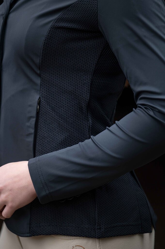 Close-up of a person wearing a dark jacket with a textured back panel.