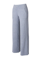 Person wearing light gray wide-leg pants on a white background