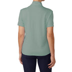 Person wearing a light green polo shirt on a white background