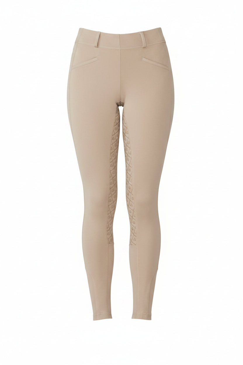 Beige leggings worn by a person on a white background