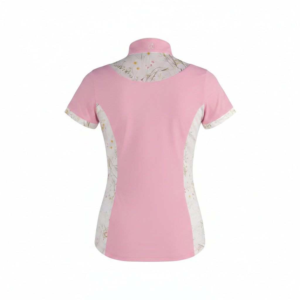 a pink athletic shirt with floral details and purple riding pants on a gray background