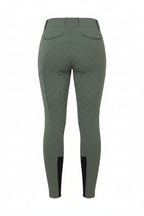 Green riding pants worn by a person on a gray background