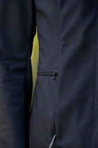 Close-up of a dark blue equestrian show jacket with a zipper detail