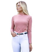 Woman wearing a pink long-sleeve top and white pants on a white background
