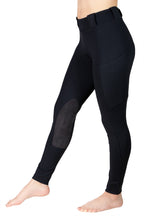 Black riding pants with knee patches on a white background