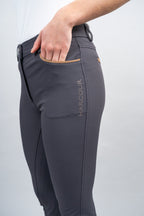 Gray riding pants with 'Harcour' branding on a light gray background