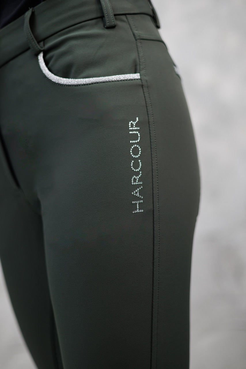 Dark green equestrian pants with 'HARCOUR' branding on a gray background