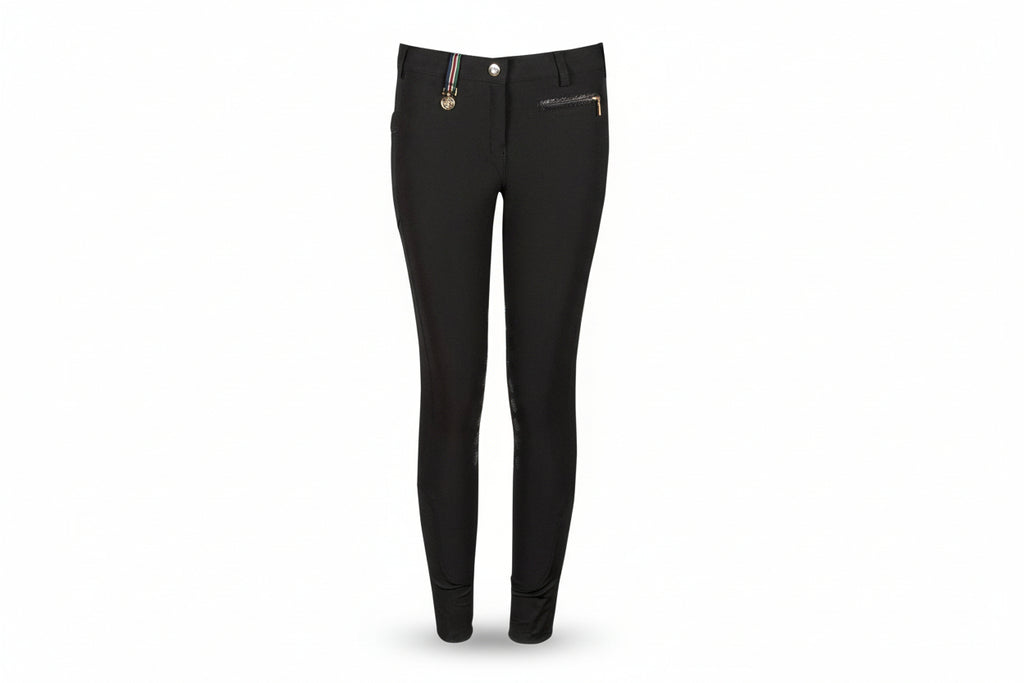 Black riding pants with a brand logo on a beige background