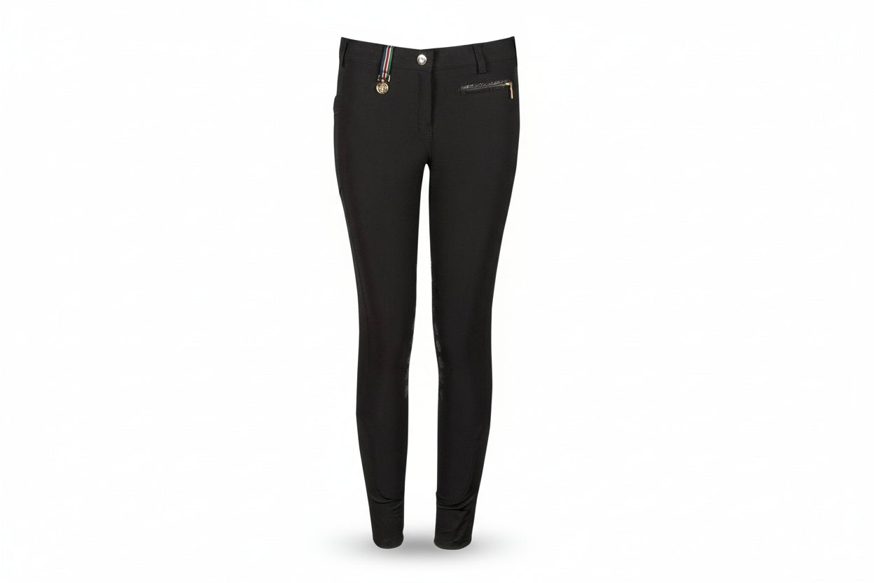 Black riding pants with a brand logo on a beige background