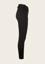 Black riding pants on a beige background