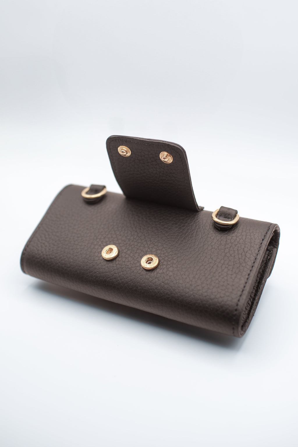 Brown leather wallet with gold buttons on a white background