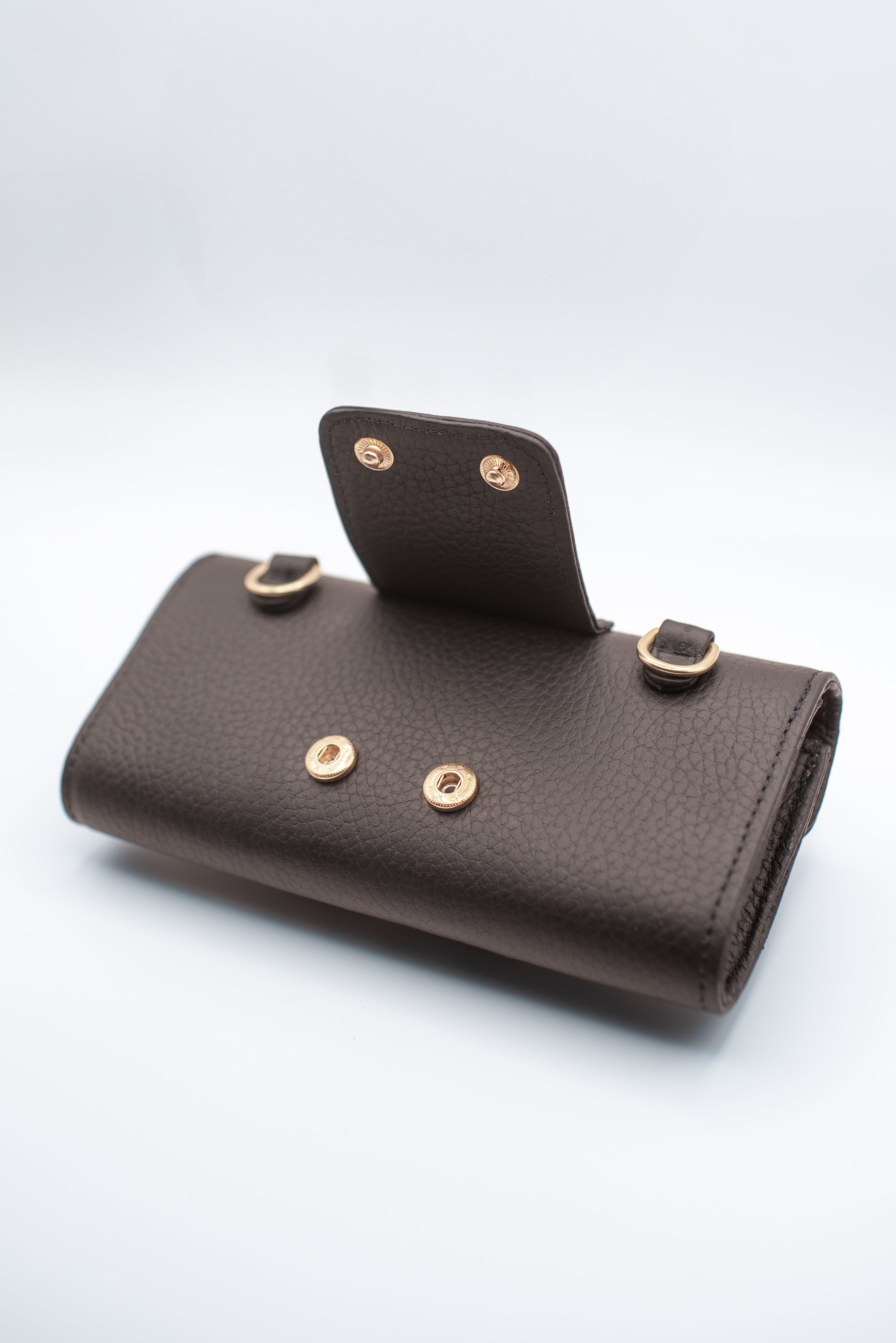 Brown leather wallet with gold buttons on a white background