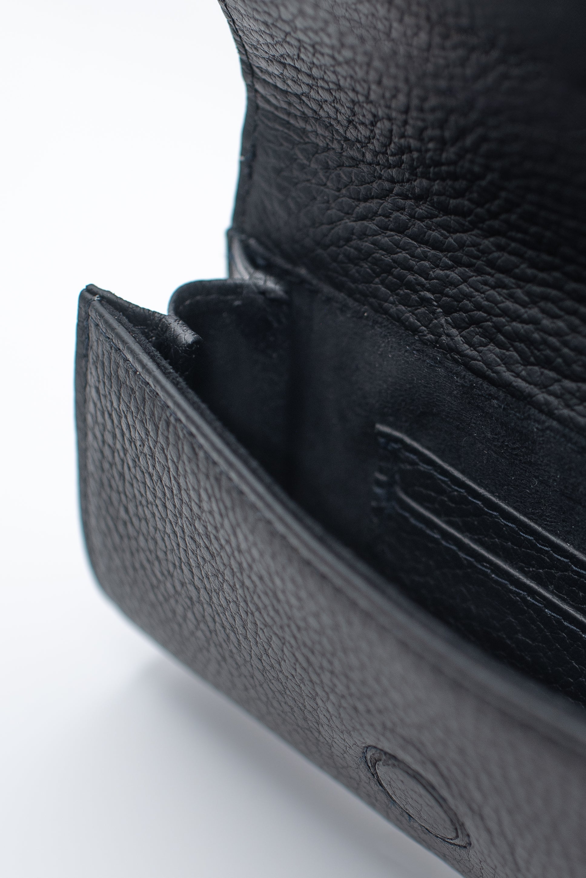 Close-up of a black leather wallet on a white background