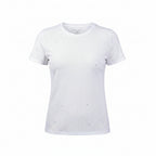Woman wearing a white textured t-shirt and beige pants on a white background