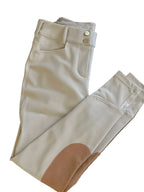 Beige pants with a patch on a wooden surface