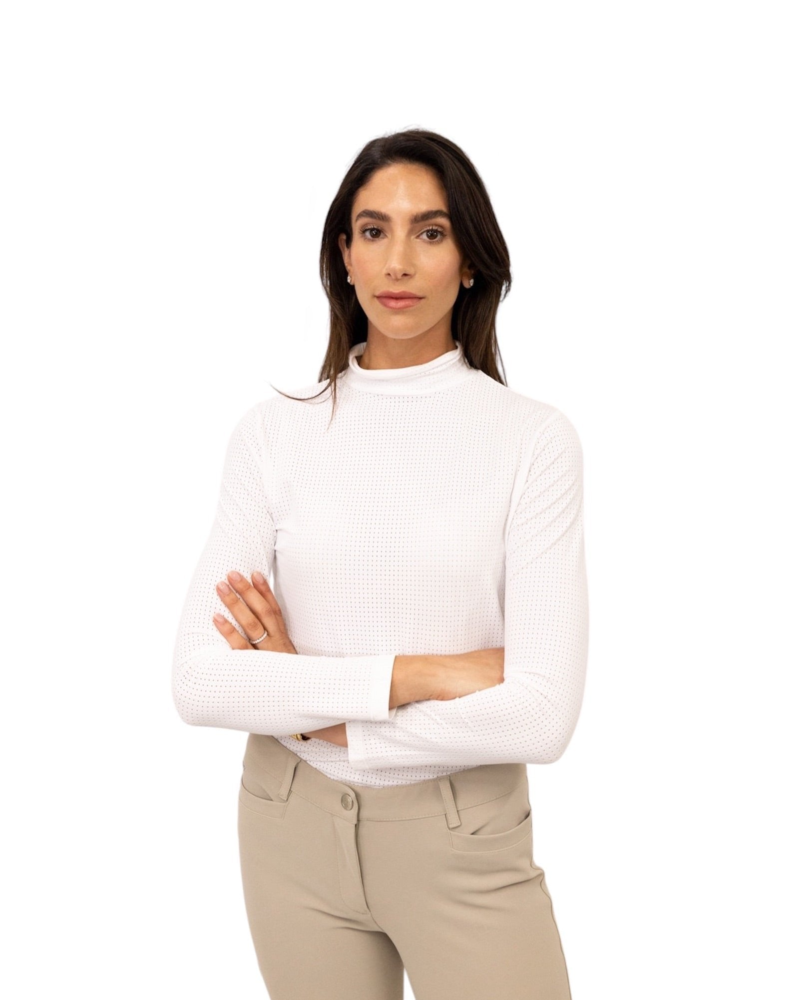 Woman wearing a white sweater and beige pants on a white background