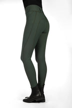 Green riding pants with black boots on a white background