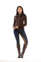 Woman wearing a brown jacket, blue pants with brown accents, and brown boots on a white background