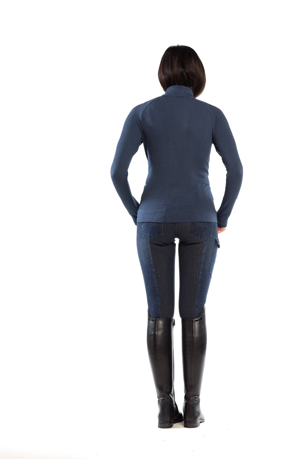 Person wearing a blue long-sleeve top and dark pants on a white background
