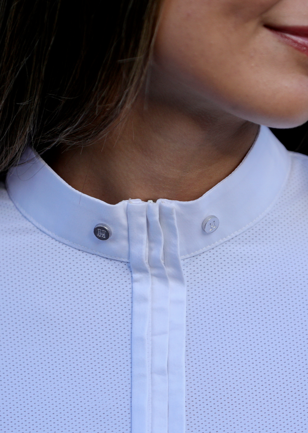 Close-up of a person wearing a light blue textured shirt with a collar.