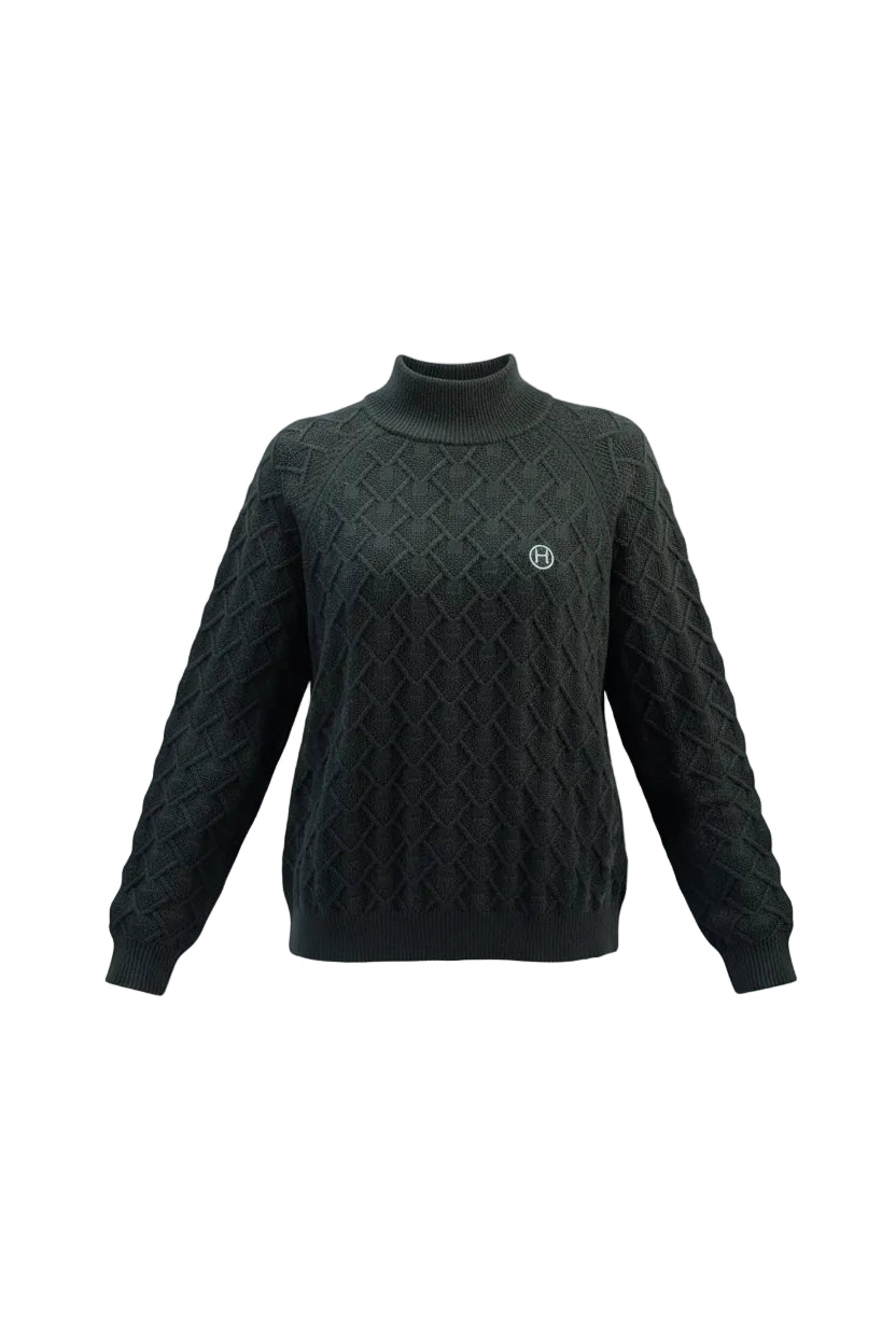 Woman wearing a black cable knit sweater with a logo on a gray background