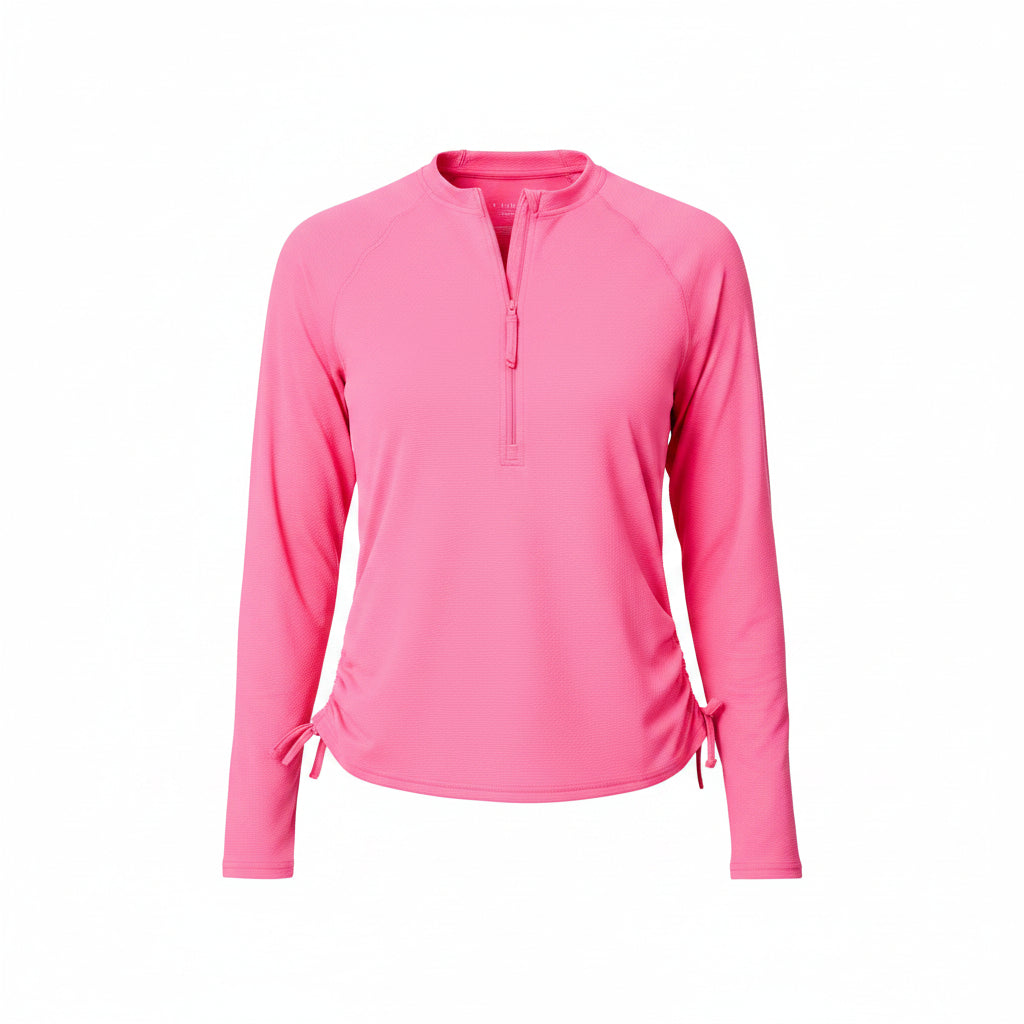 Woman wearing a pink long-sleeve shirt and blue shorts on a white background