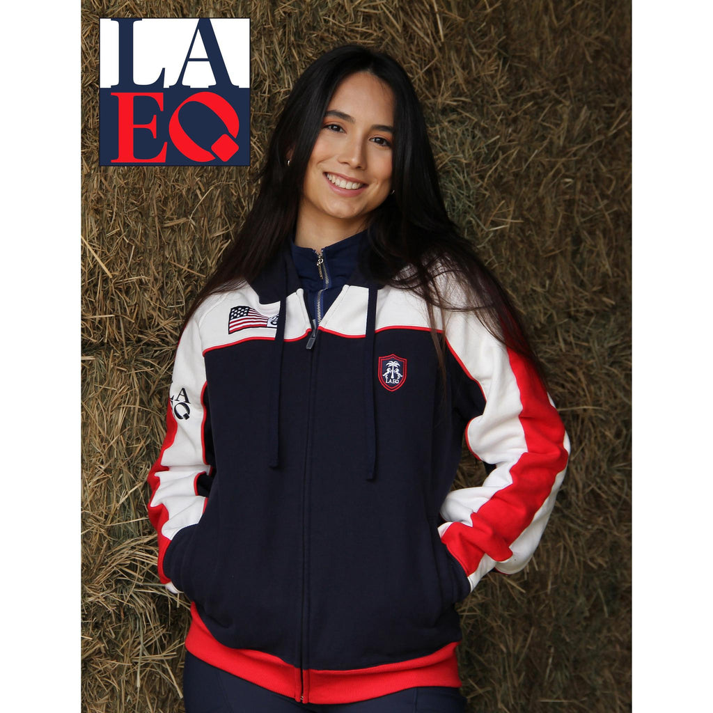 Person wearing a navy, white, and red jacket with LAEQ logo on a hay background
