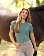 Woman standing next to a horse in an outdoor setting