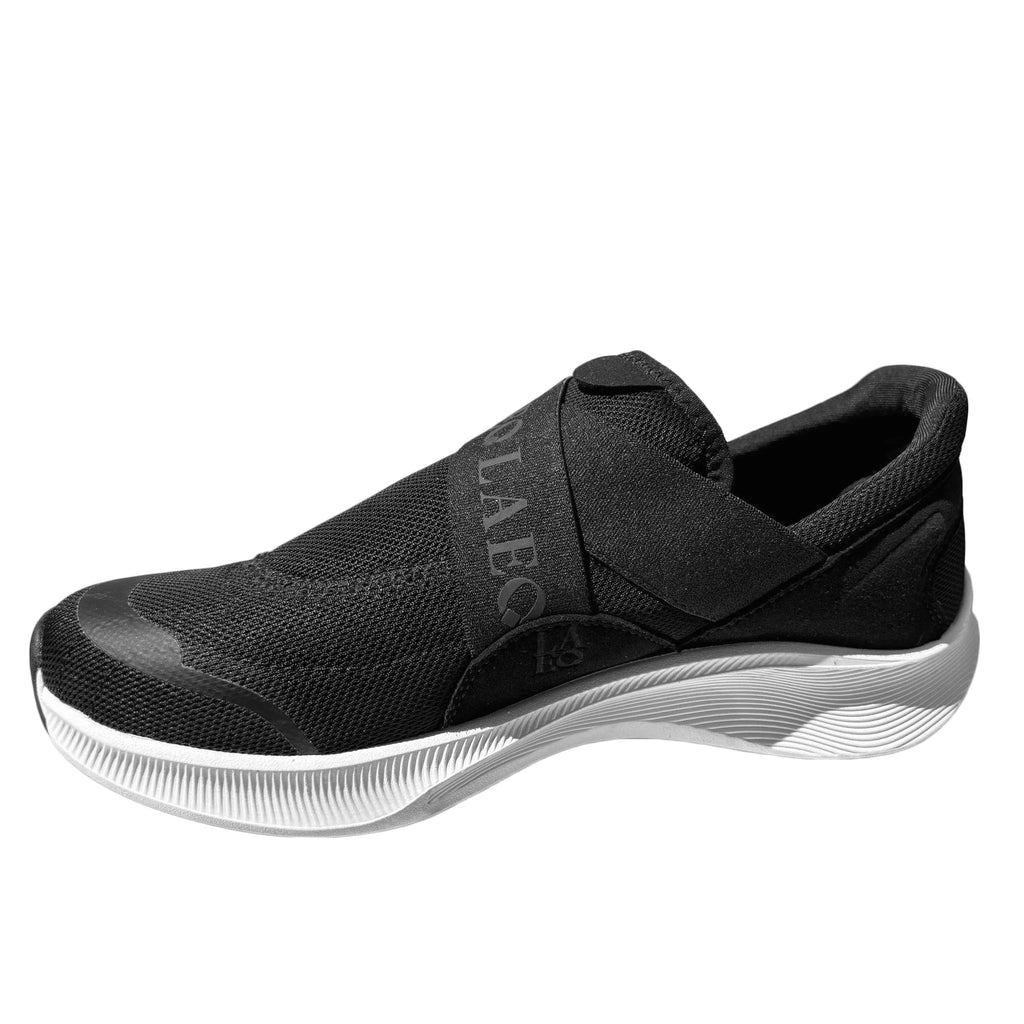Black and white cleated shoe with New Balance logo on a white background