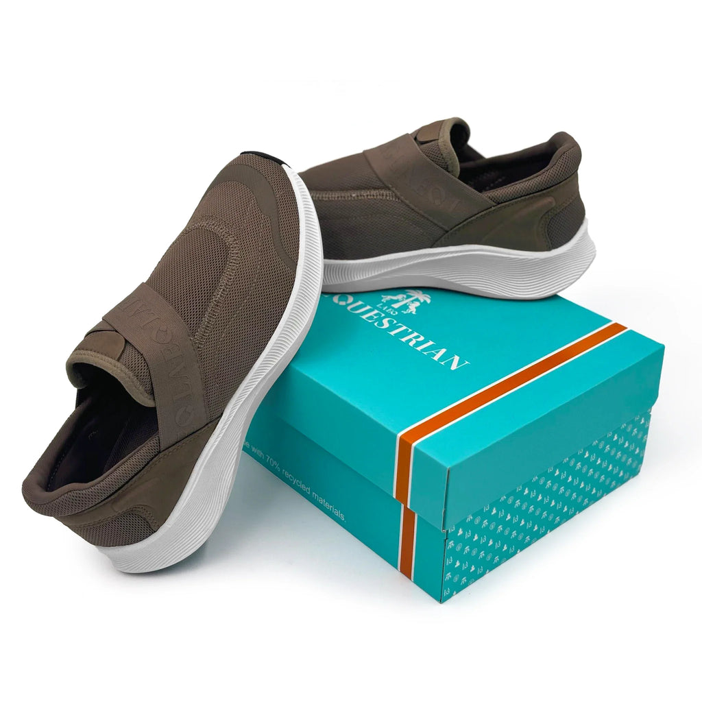 Brown slip-on shoes with white soles on a blue box with 'Equestrian' branding.