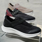 Black and brown shoes with 'Laeot' branding on a reflective surface.