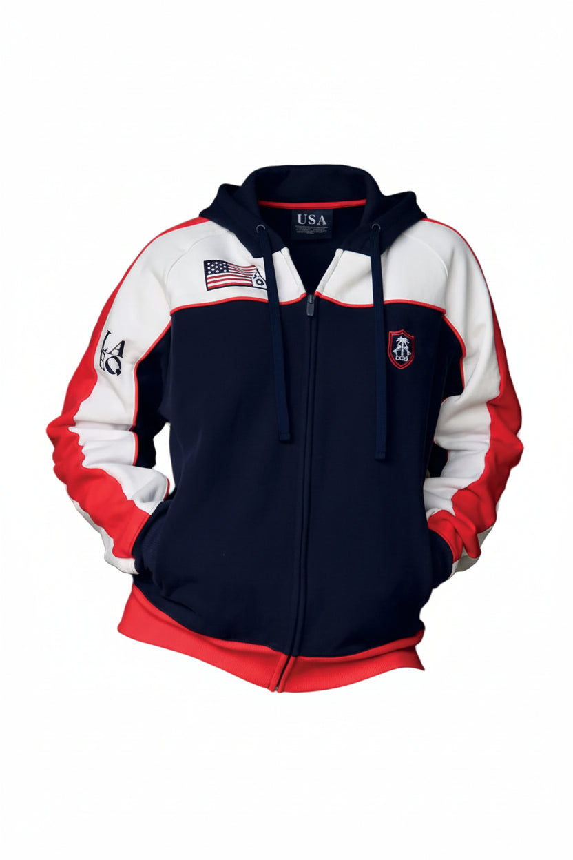 Person wearing a navy, white, and red jacket with an American flag emblem against a hay bale background.
