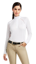 Woman wearing a white long-sleeve shirt and beige pants on a white background